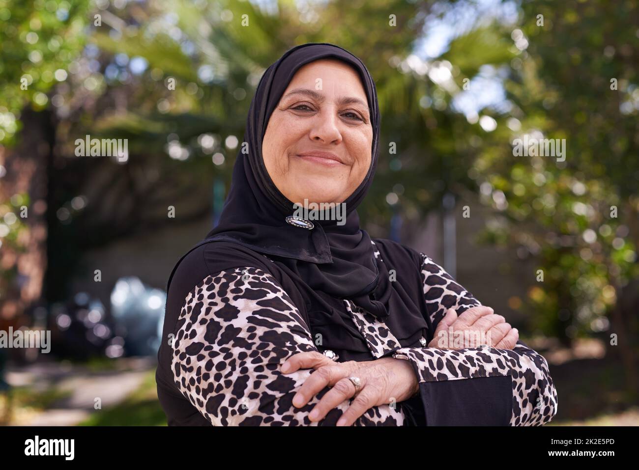 She loves her heritage. Portrait of a mature muslim woman standing outside. Stock Photo