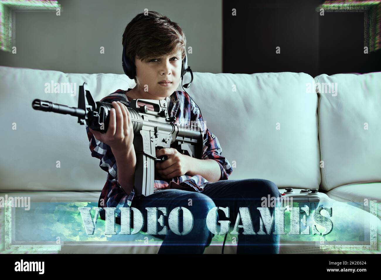 Lock and load time. Shot of a young boy playing violent video games. Stock Photo