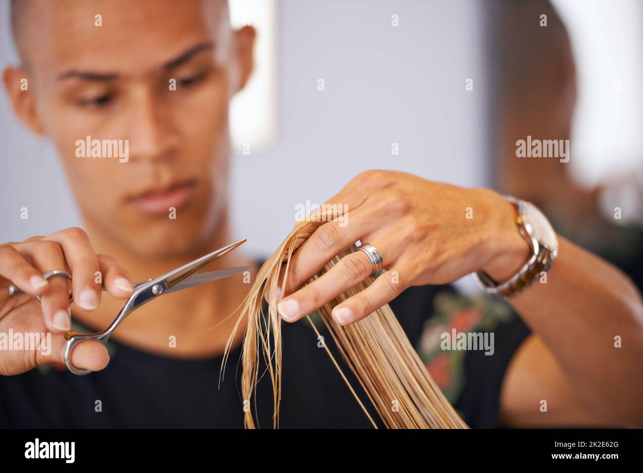 He knows his hair. Cropped shot of a male hairdresser cutting a clients hair. Stock Photo