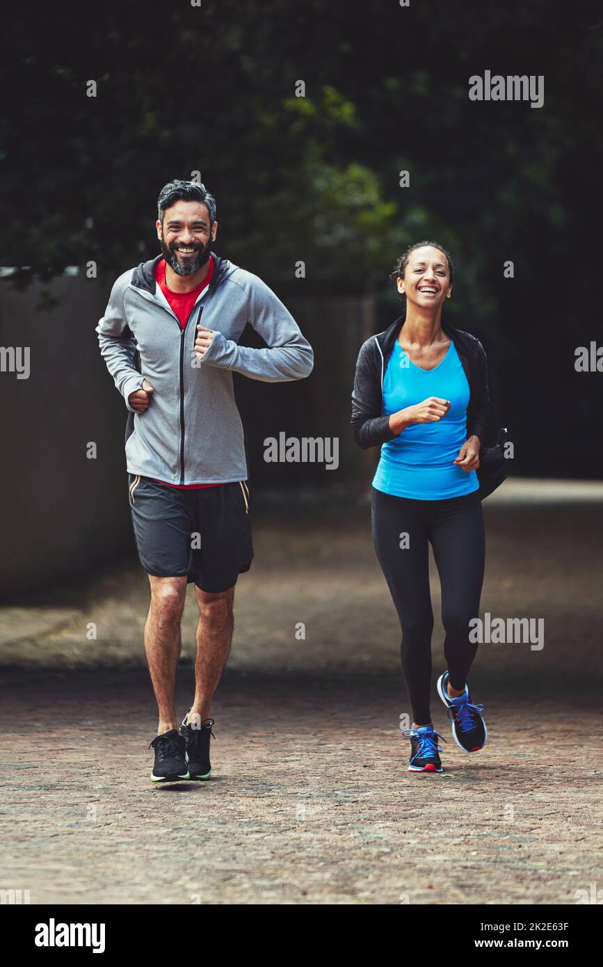 Ditch the gym and exercise outside. Shot of a couple out running together. Stock Photo