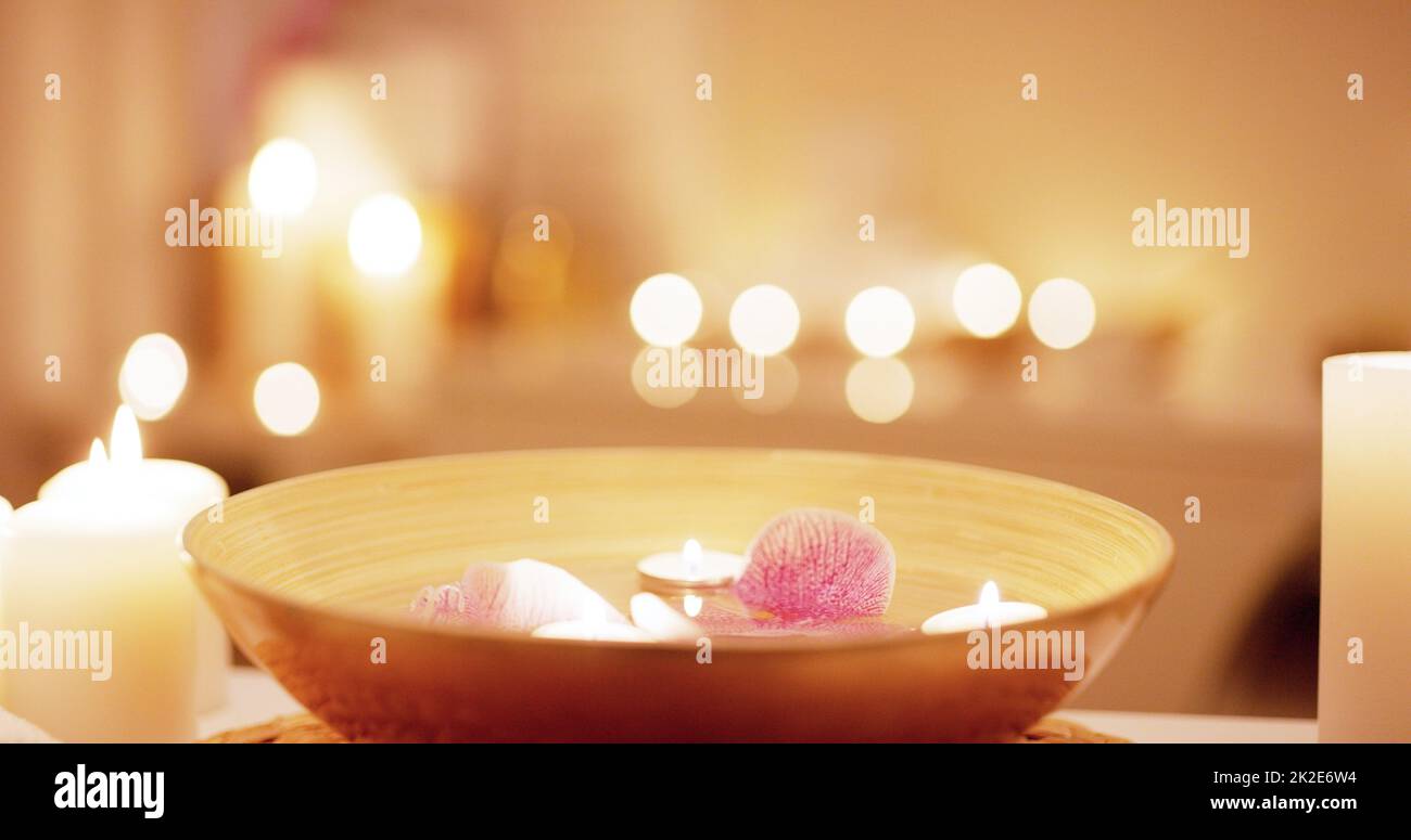 We help put your mind and body to ease. Still life shot of various spa essentials on a table. Stock Photo