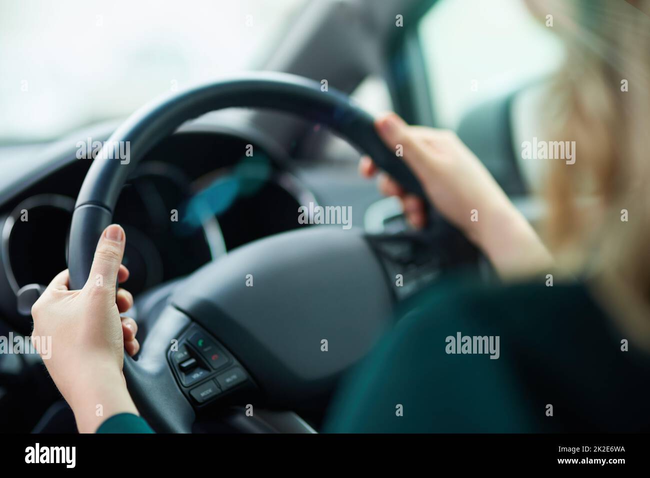Journeying along. Shot of a woman holding onto a steering wheel while