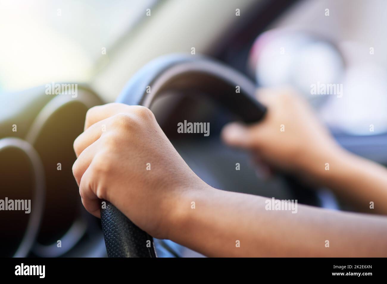 Enjoy the journey. Shot of hands holding onto a steering wheel while