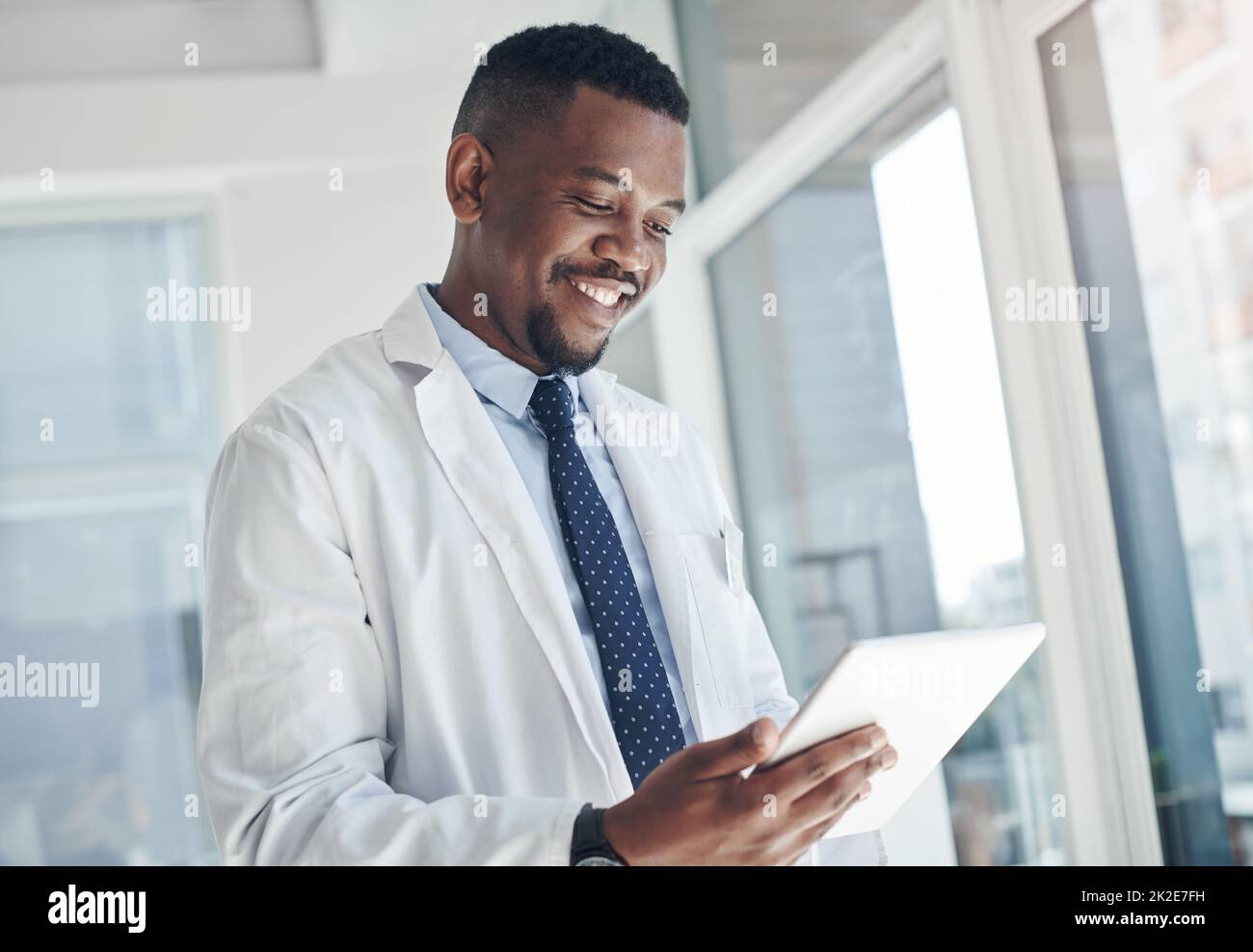 I found the information I needed. Shot of a young doctor using a digital tablet in an office. Stock Photo