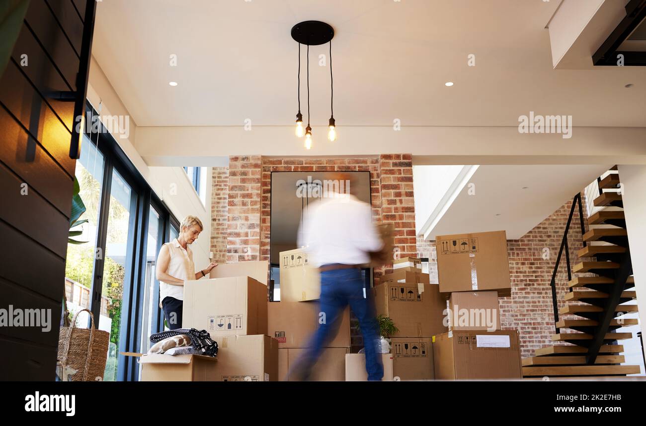 Ready, steady, pack. Shot of a mature couple unpacking boxes on moving day. Stock Photo