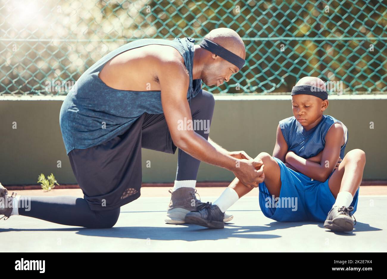 Basketball father and son with knee injury, pain and band aid from