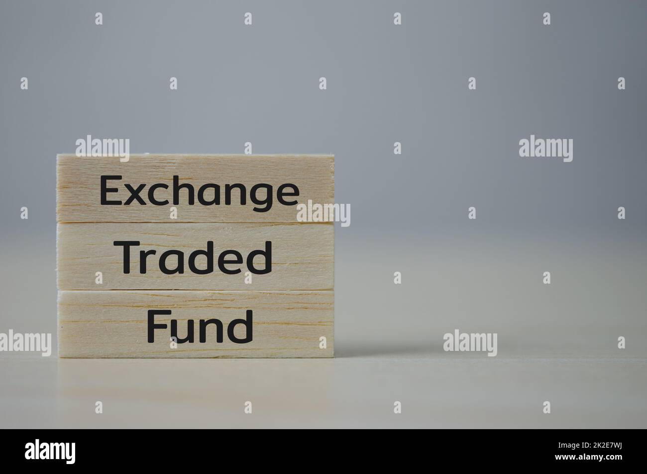 wooden cube block icon ETF Exchange Traded Fund on table.Business stock market finance Index Fund Concept. Stock Photo