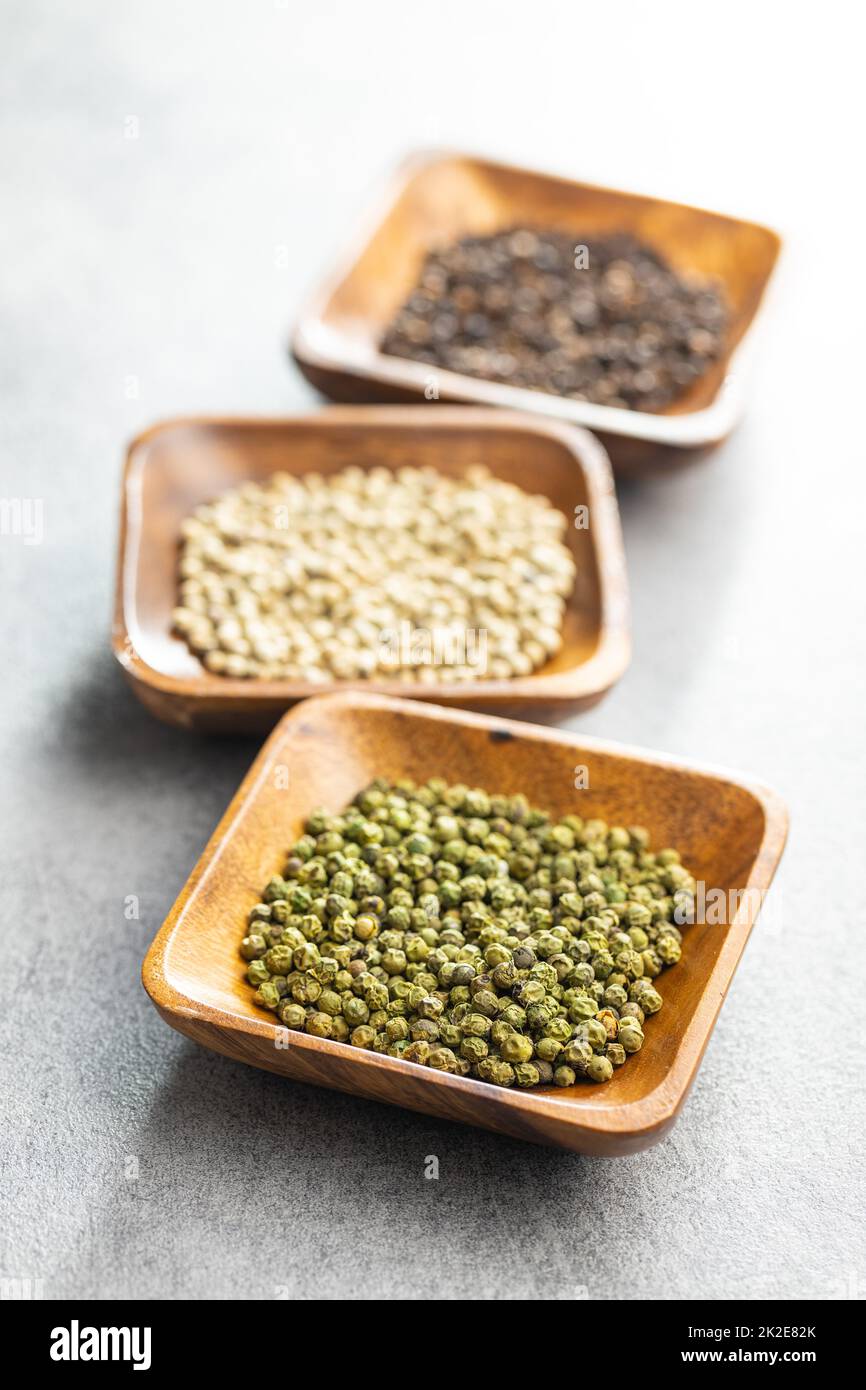 Three different types of pepper spice. Green, white and black
