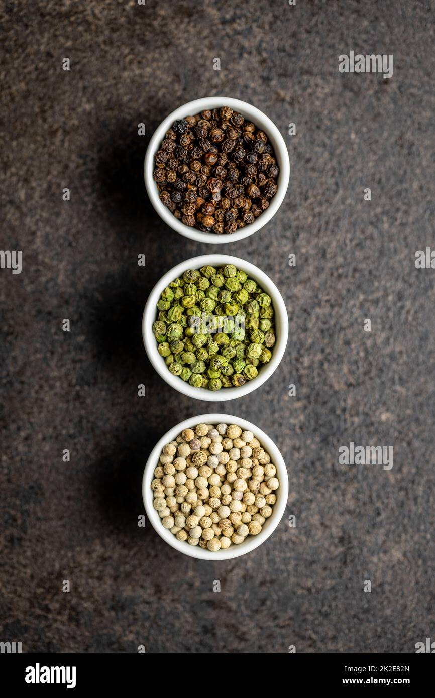 Three different types of pepper spice. Green, white and black