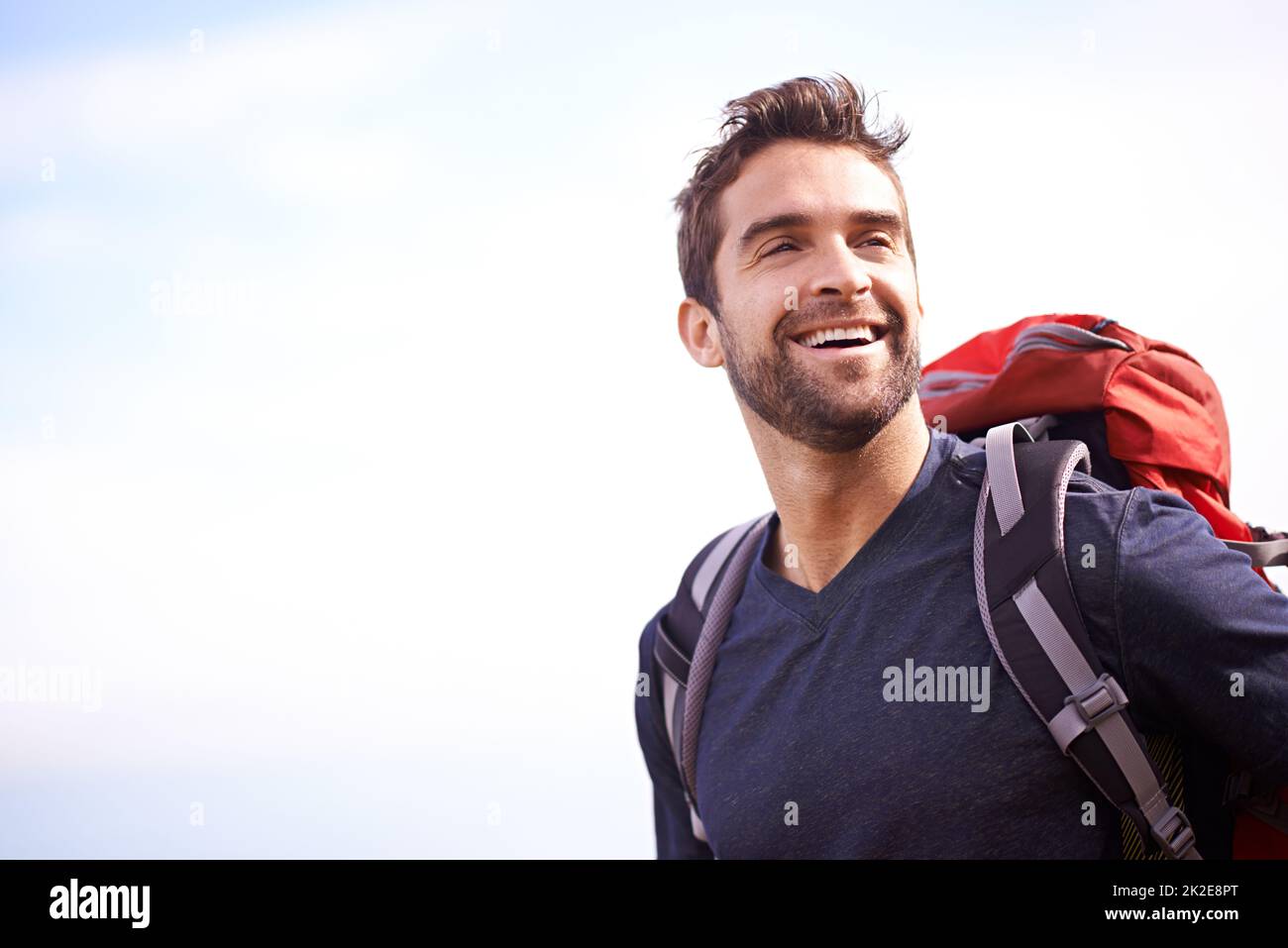 Its just better when youre outside. Shot of a young man enjoying a hike through the mountains. Stock Photo