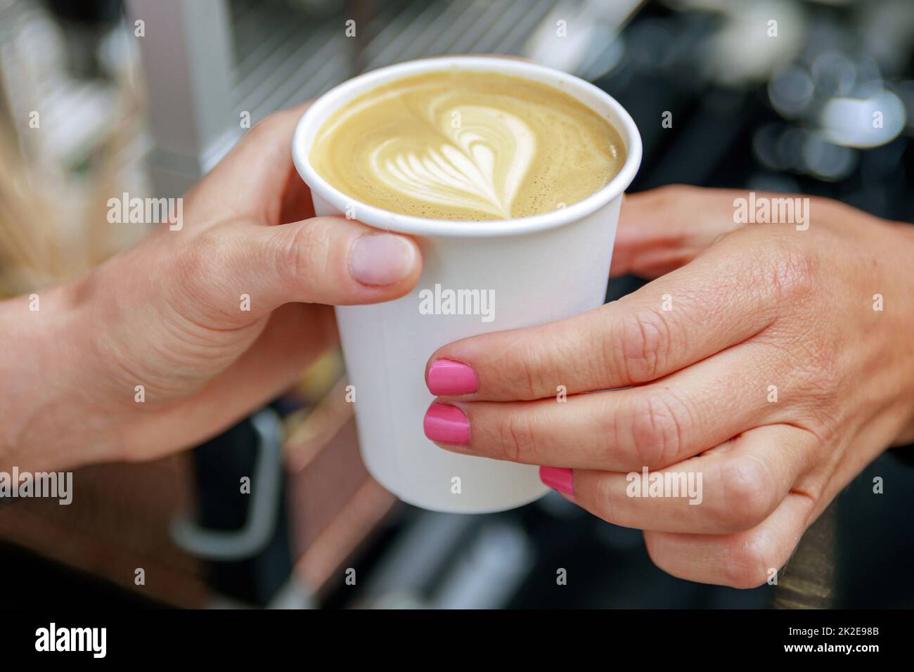 Barista giving to the customer paper cup with cappuccino Stock Photo ...