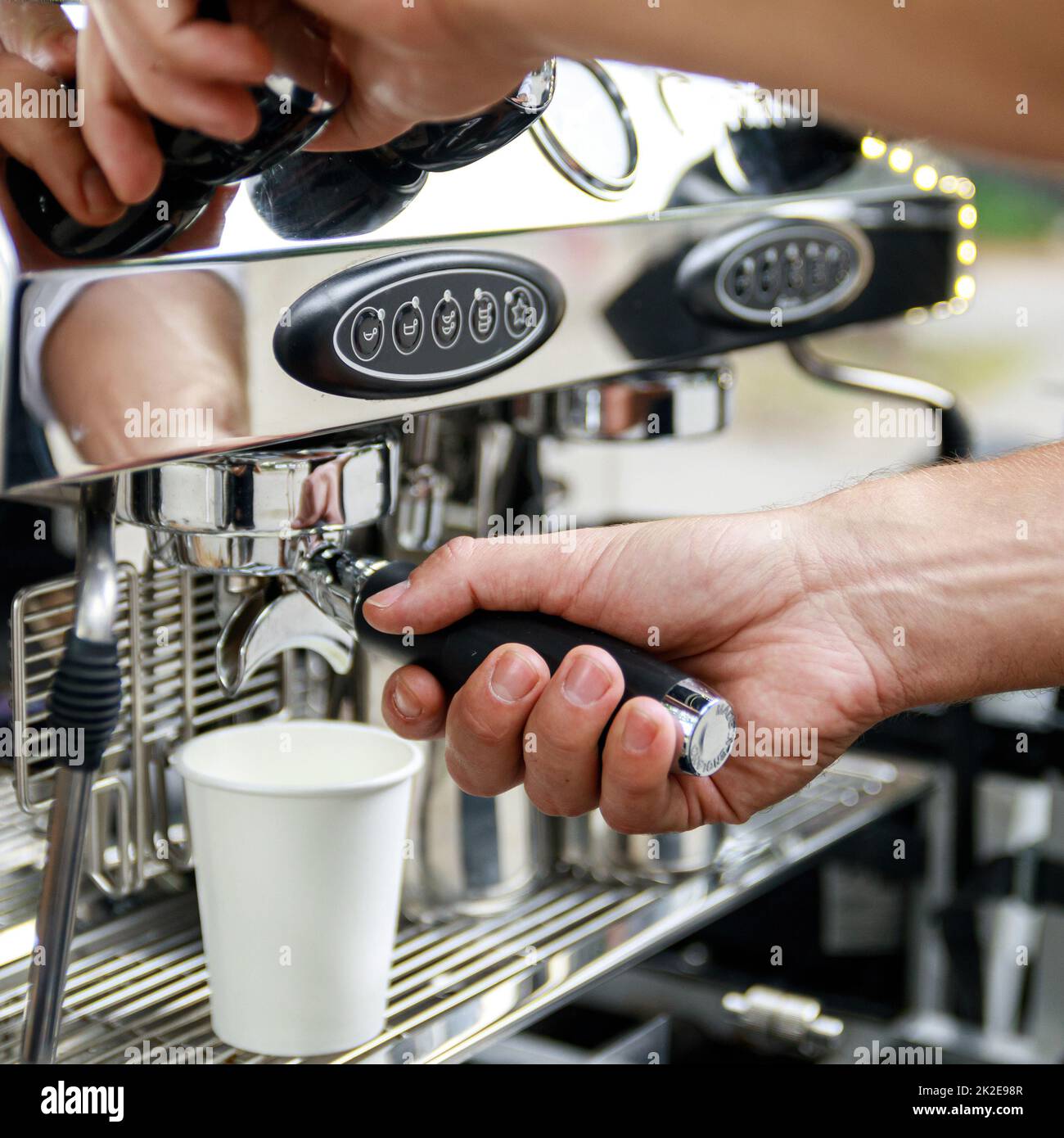 Barista making coffee using professional espresso machine Stock Photo