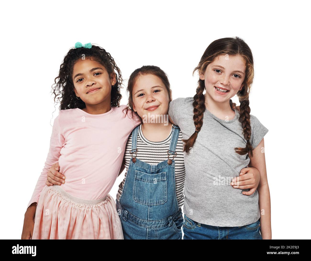 Friends like us are forever. Studio portrait of a group of three happy girls embracing one another against a white background. Stock Photo