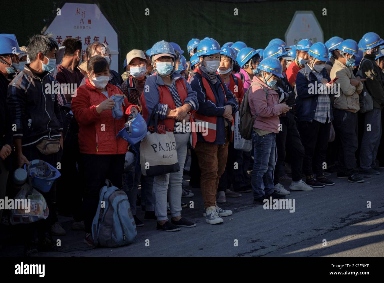 Workers gathers to begin their shift at the construction site of the new Workers' Stadium in Beijing, China, September 23, 2022. REUTERS/Thomas Peter Stock Photo