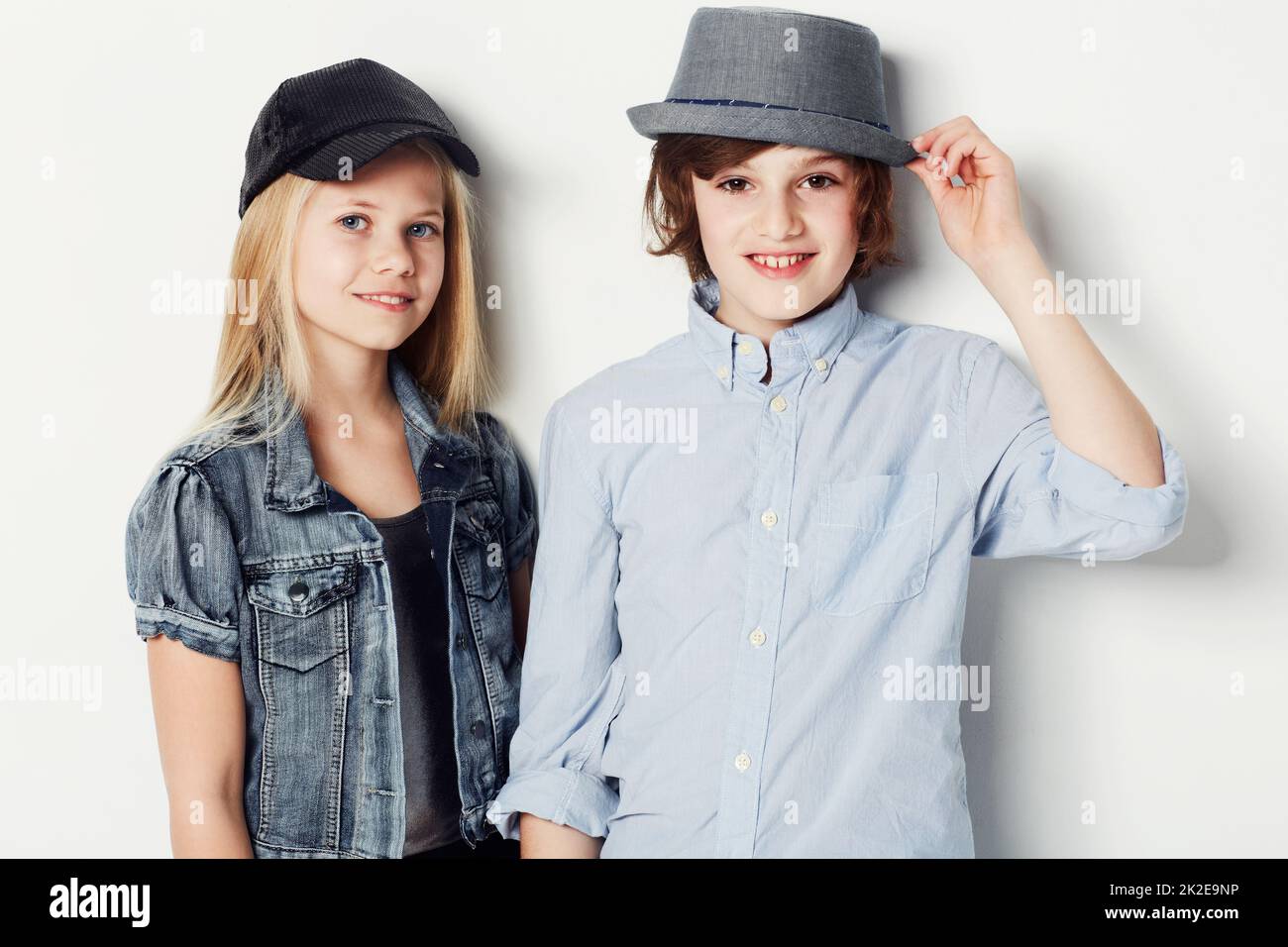 Hes going to be the perfect gentlemen. Portrait of two fashionable young kids posing in the studio. Stock Photo