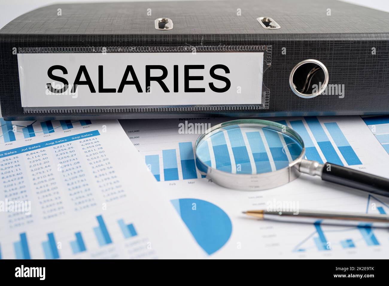 Salaries. Binder data finance report business with graph analysis in office. Stock Photo