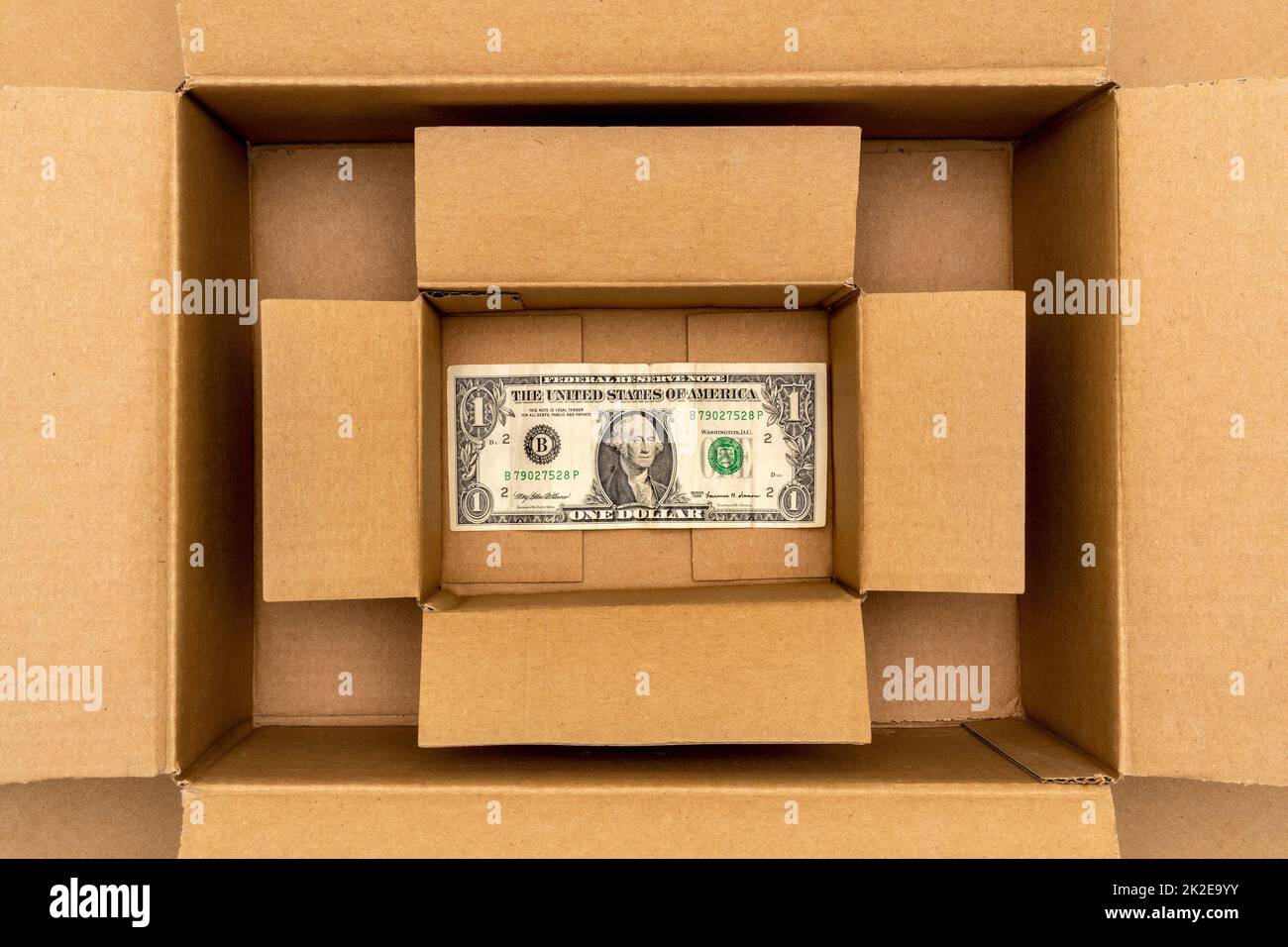One dollar on the bottom of cardboard box Stock Photo