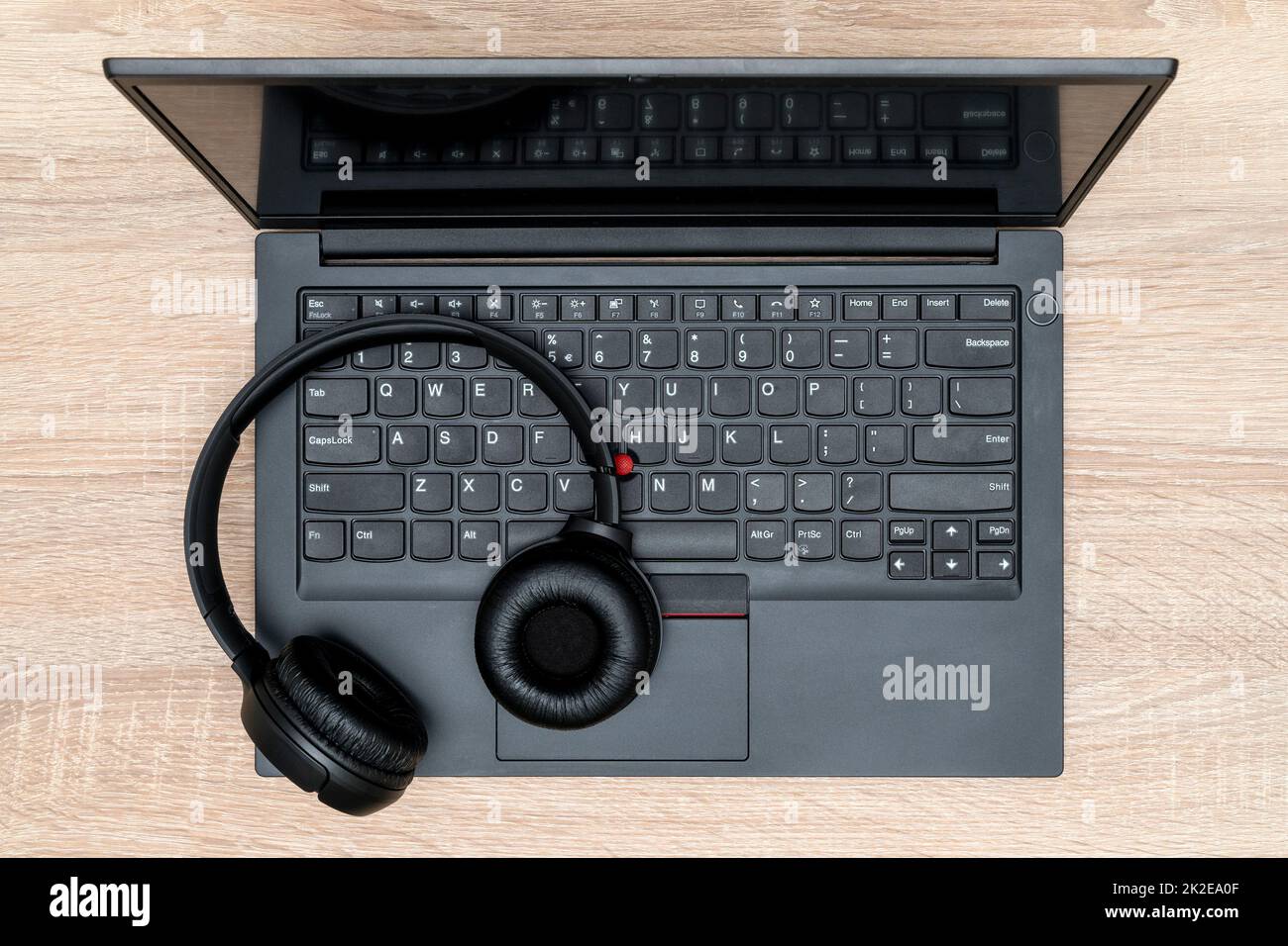 Wireless headphones on the laptop keyboard Stock Photo