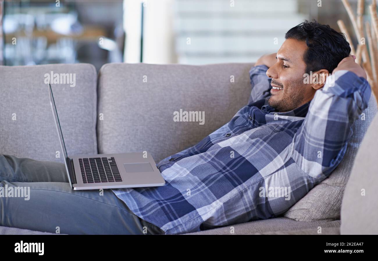 Hands-free entertainment. A young man working on his laptop from home. Stock Photo