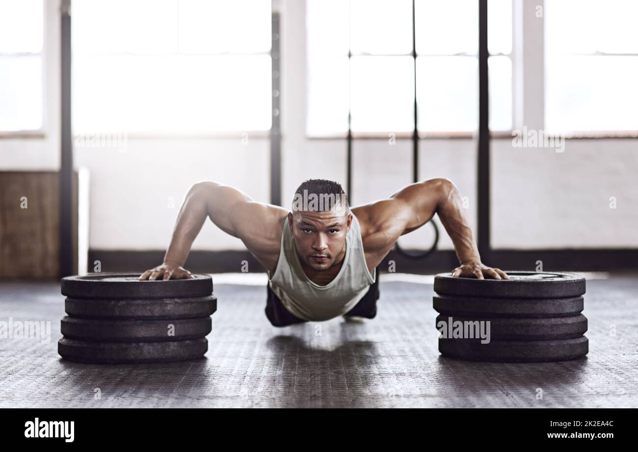 Balance and power. Full length shot of a young man working out in the gym. Stock Photo