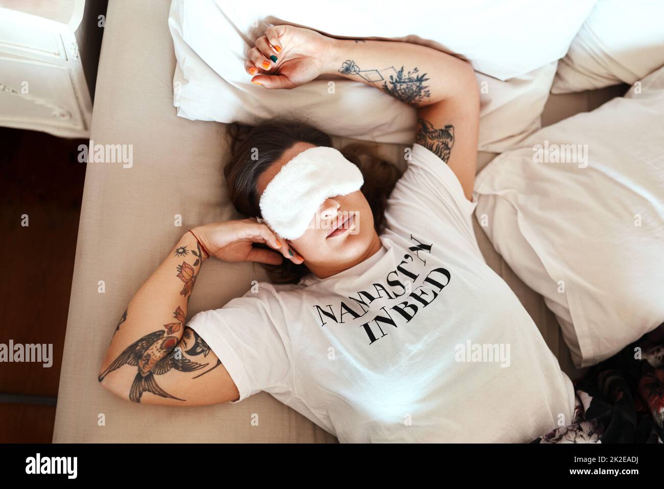 Nothing comes in between me and my beauty sleep. Cropped shot of a young woman wearing a sleeping mask while sleeping in her bed at home. Stock Photo