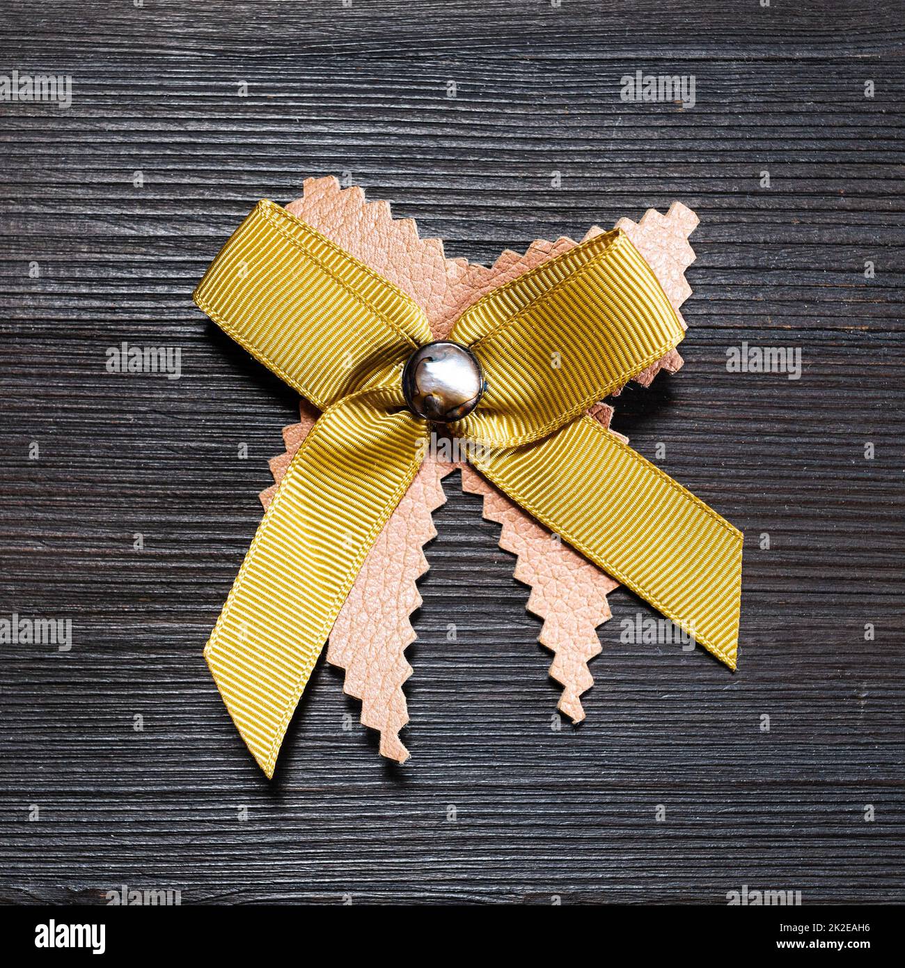 top view of bow brooch from leather and ribbon Stock Photo