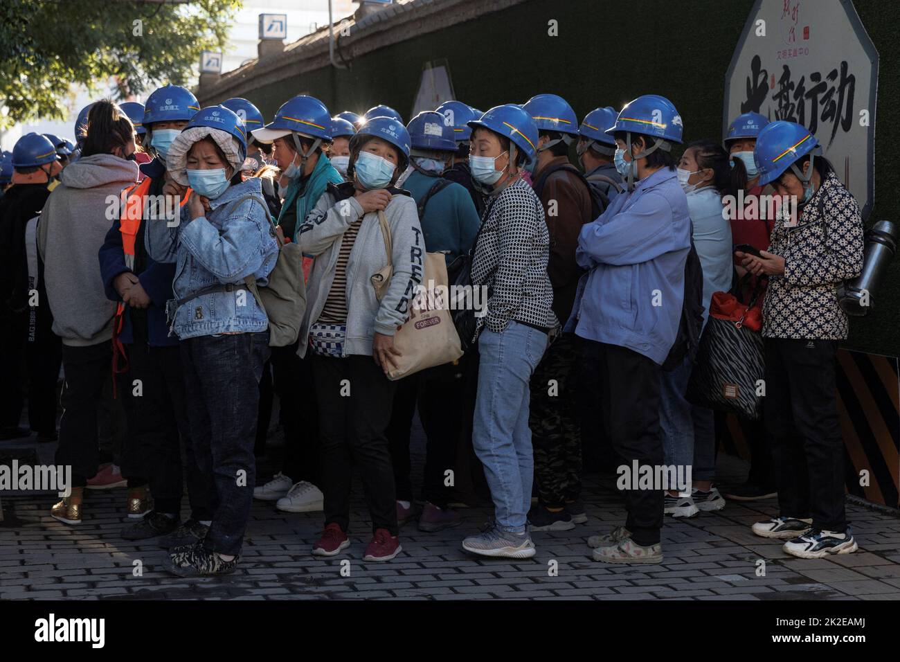 Workers gathers to begin their shift at the construction site of the new Workers' Stadium in Beijing, China, September 23, 2022. REUTERS/Thomas Peter Stock Photo