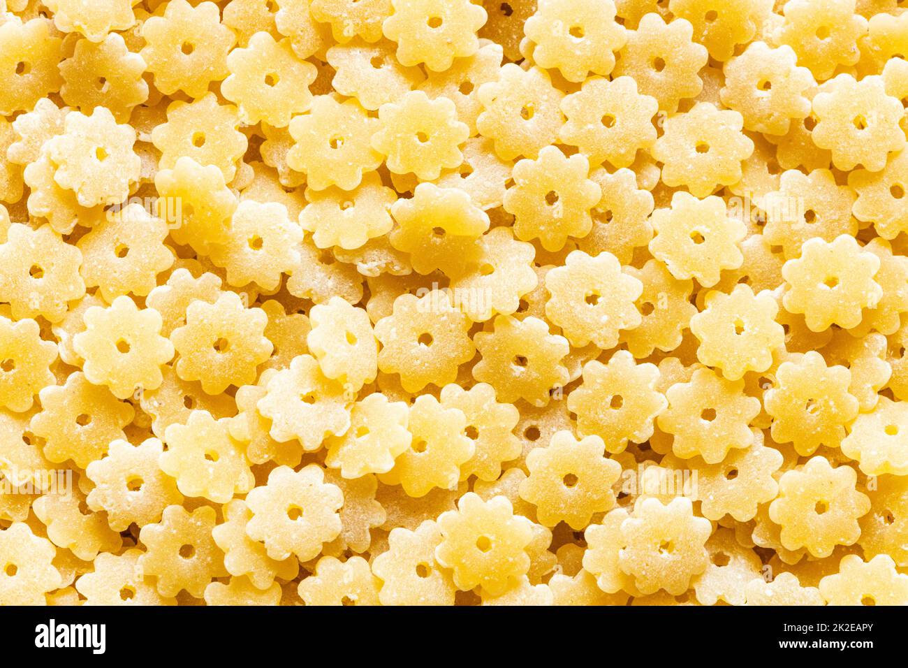 food background from uncooked stelle pasta pieces Stock Photo