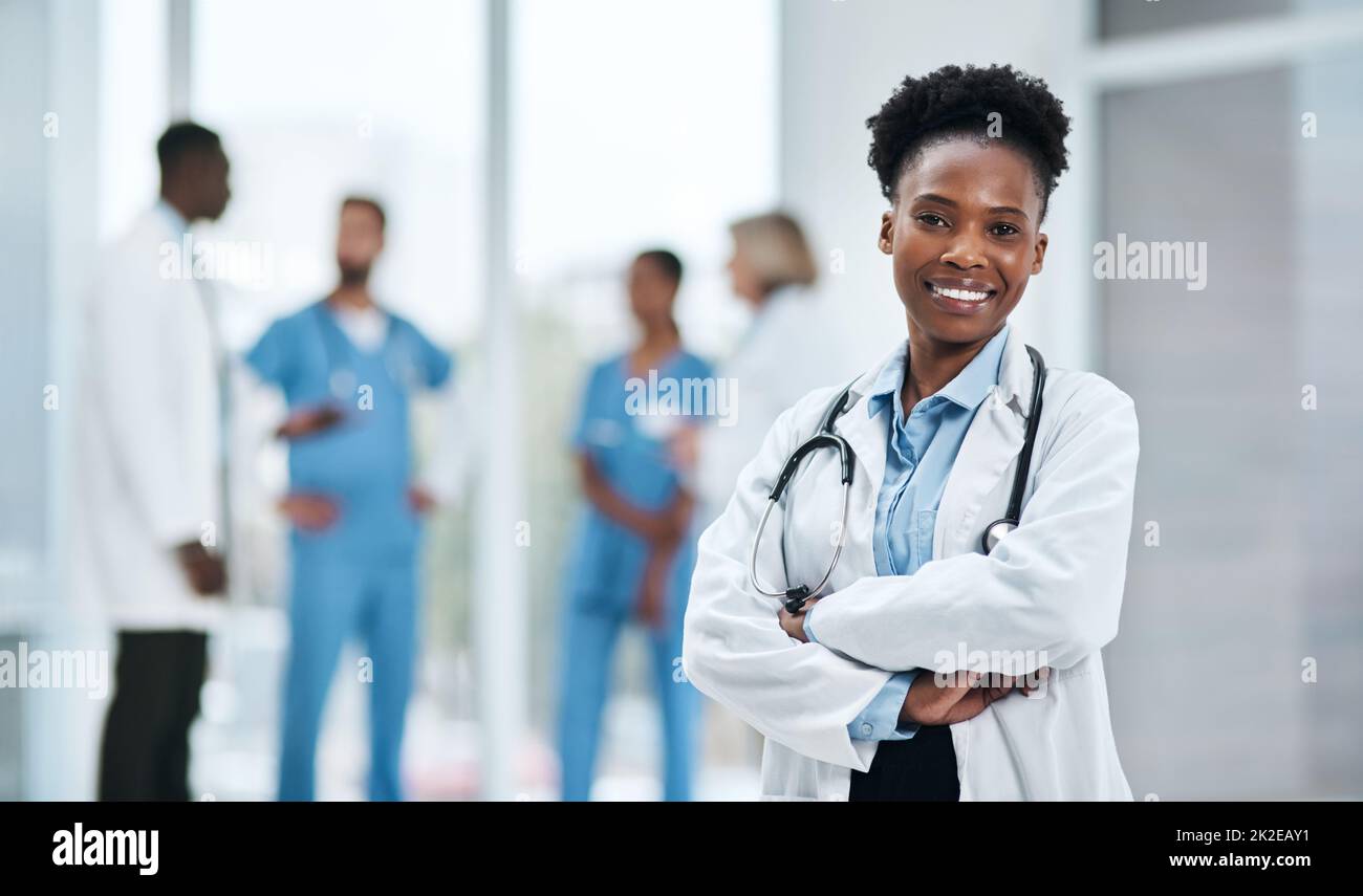 Its my mission to guide you towards better health. Portrait of a young doctor standing in a hospital. Stock Photo
