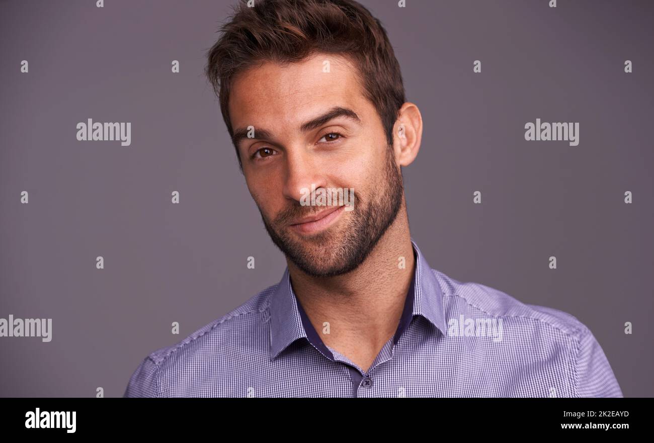 Rugged and manly. Studio shot of a handsome man against a gray