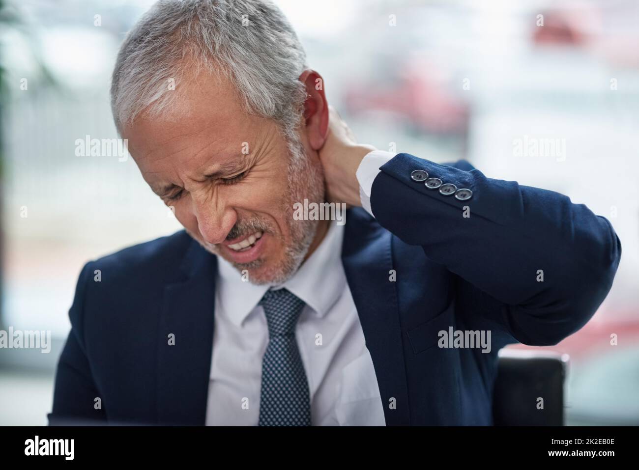 The aches and pains of office work. Shot of a mature businessman