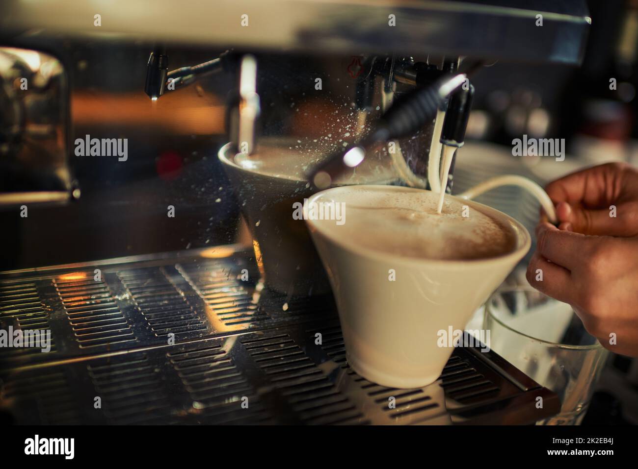 Just a dash of milk. Closeup of an unrecognizable person pouring hot