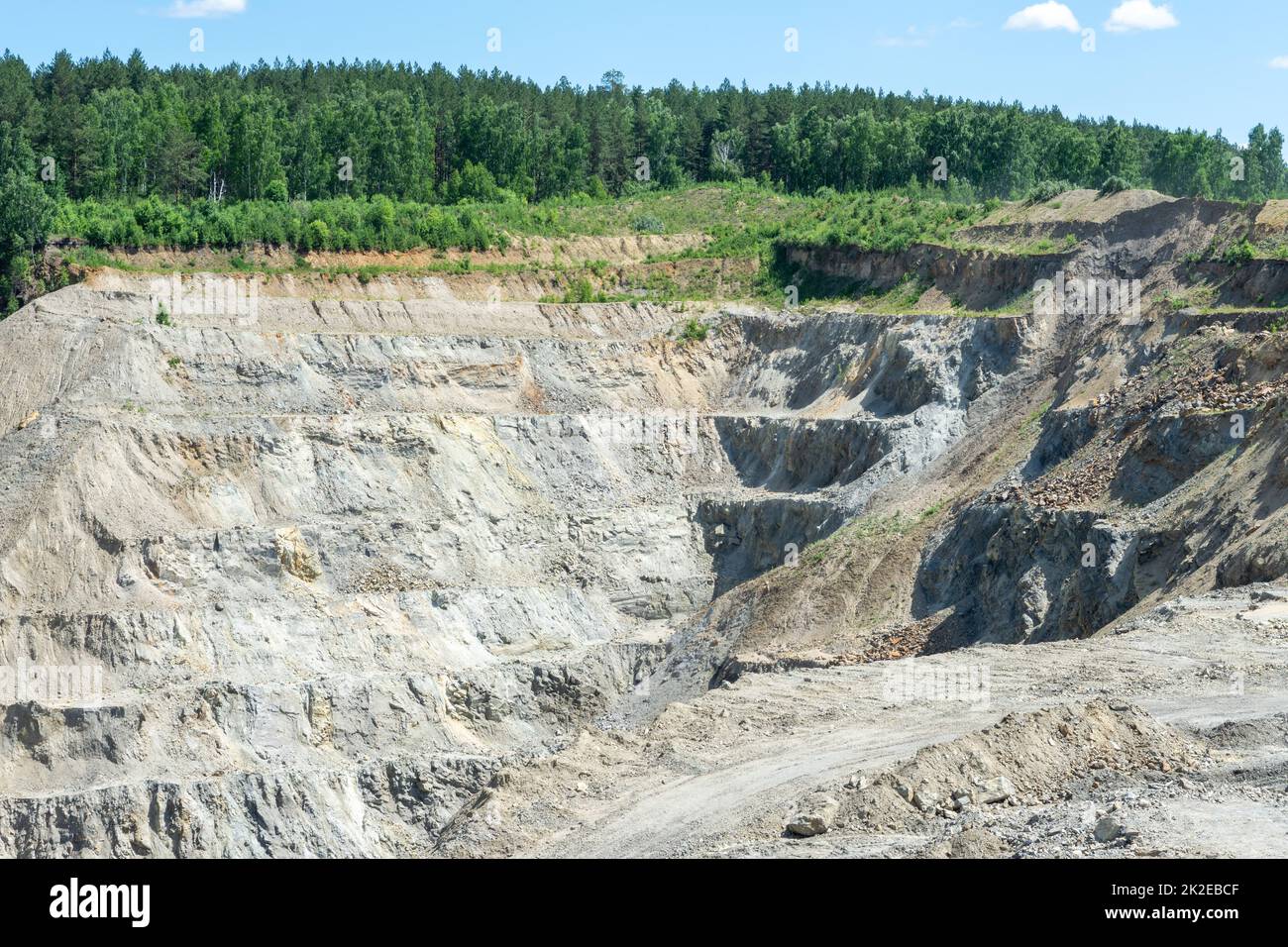 The production of graphite. Industrial background. Deep quarry for the