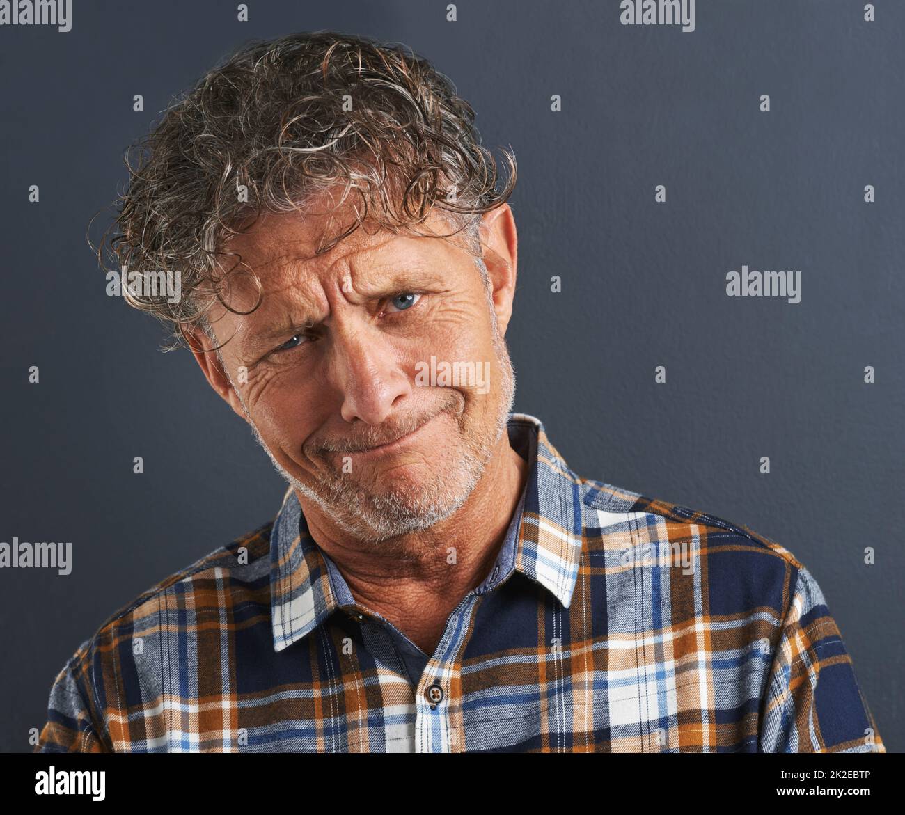 A bit befuddled. A cropped portrait of a confused-looking mature man. Stock Photo