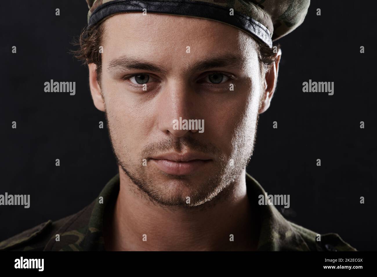 Stern soldier. Shot of a young man in military fatigues. Stock Photo