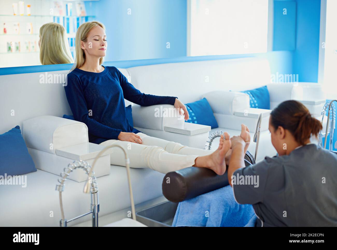 The best cure is a pedicure. Shot of a woman having her feet massaged at a beauty spa. Stock Photo
