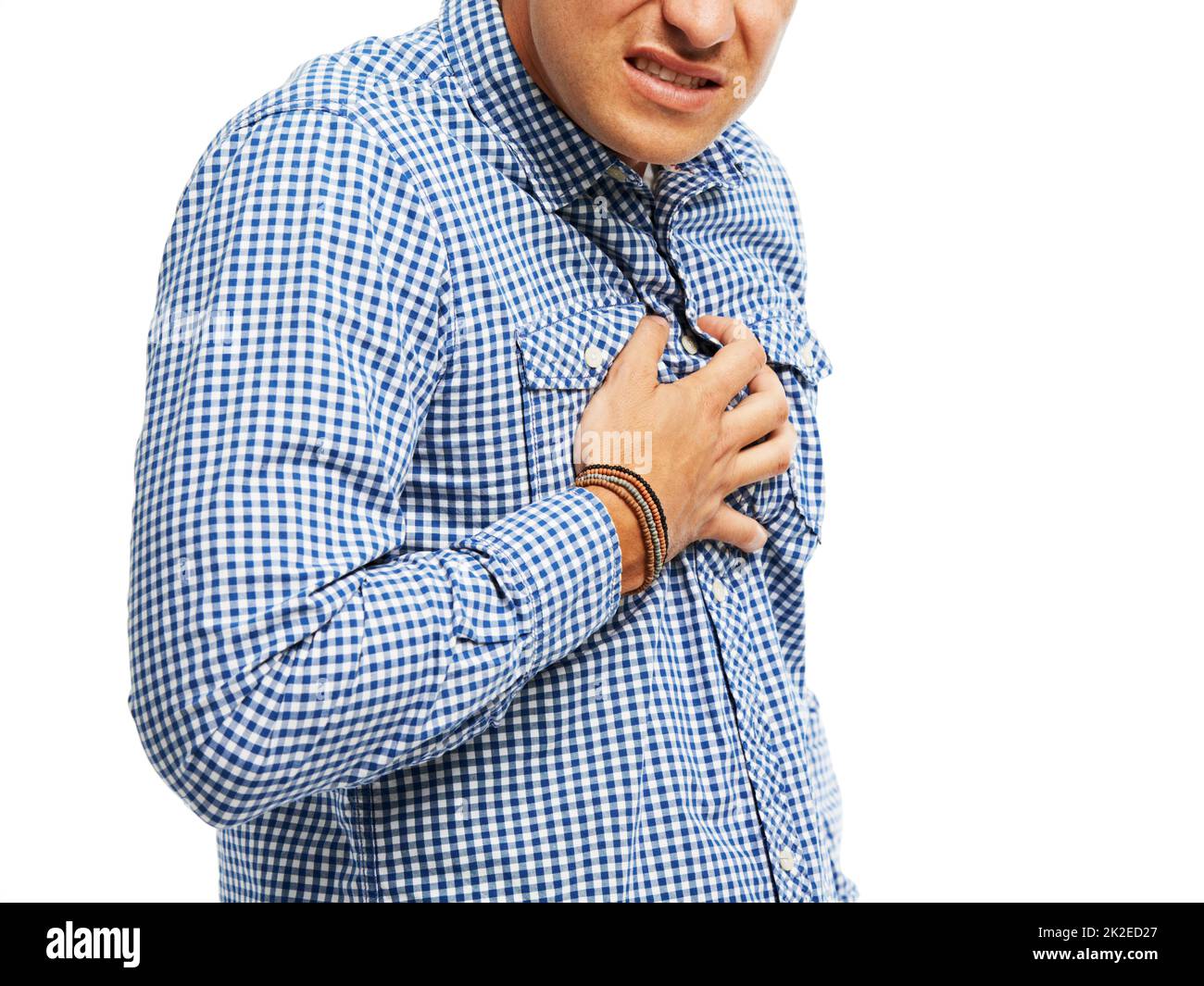 Struggling with chest pain. Young man clutching his chest in pain