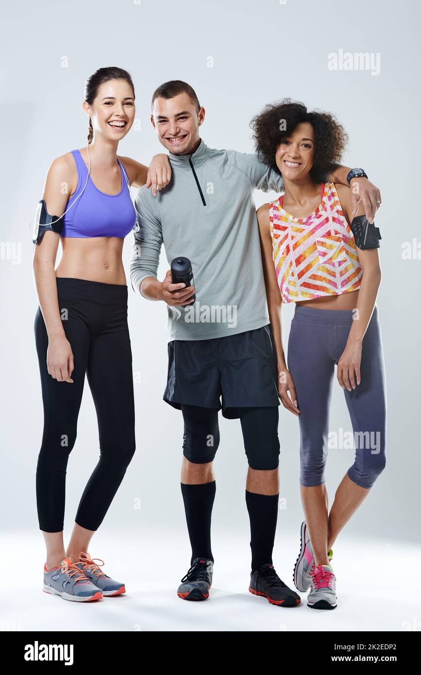 My workout buddies. Portrait of three young adults wearing sports clothing in studio. Stock Photo