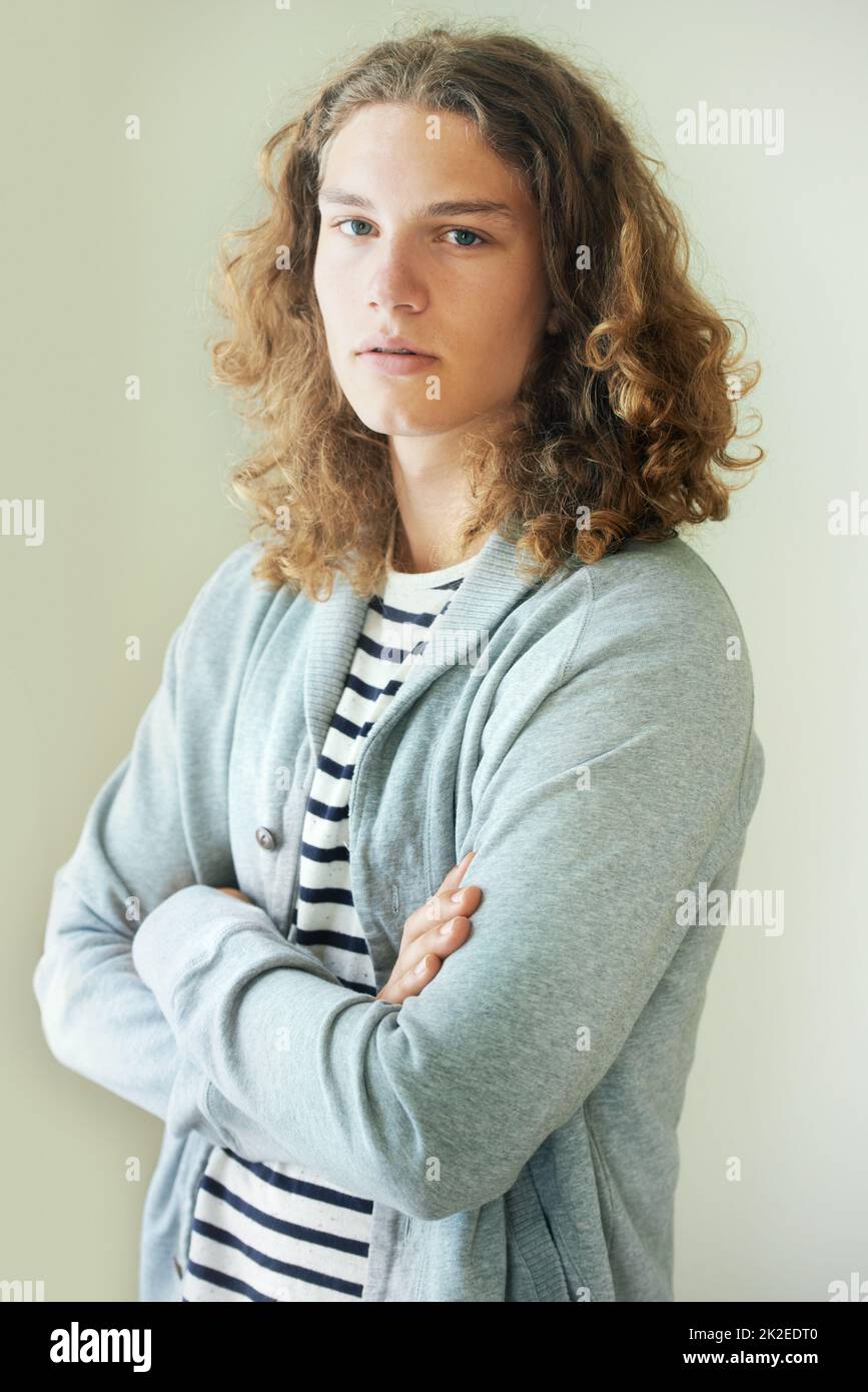 Keeping things casual. Casual young man with long, curly hair. Stock Photo