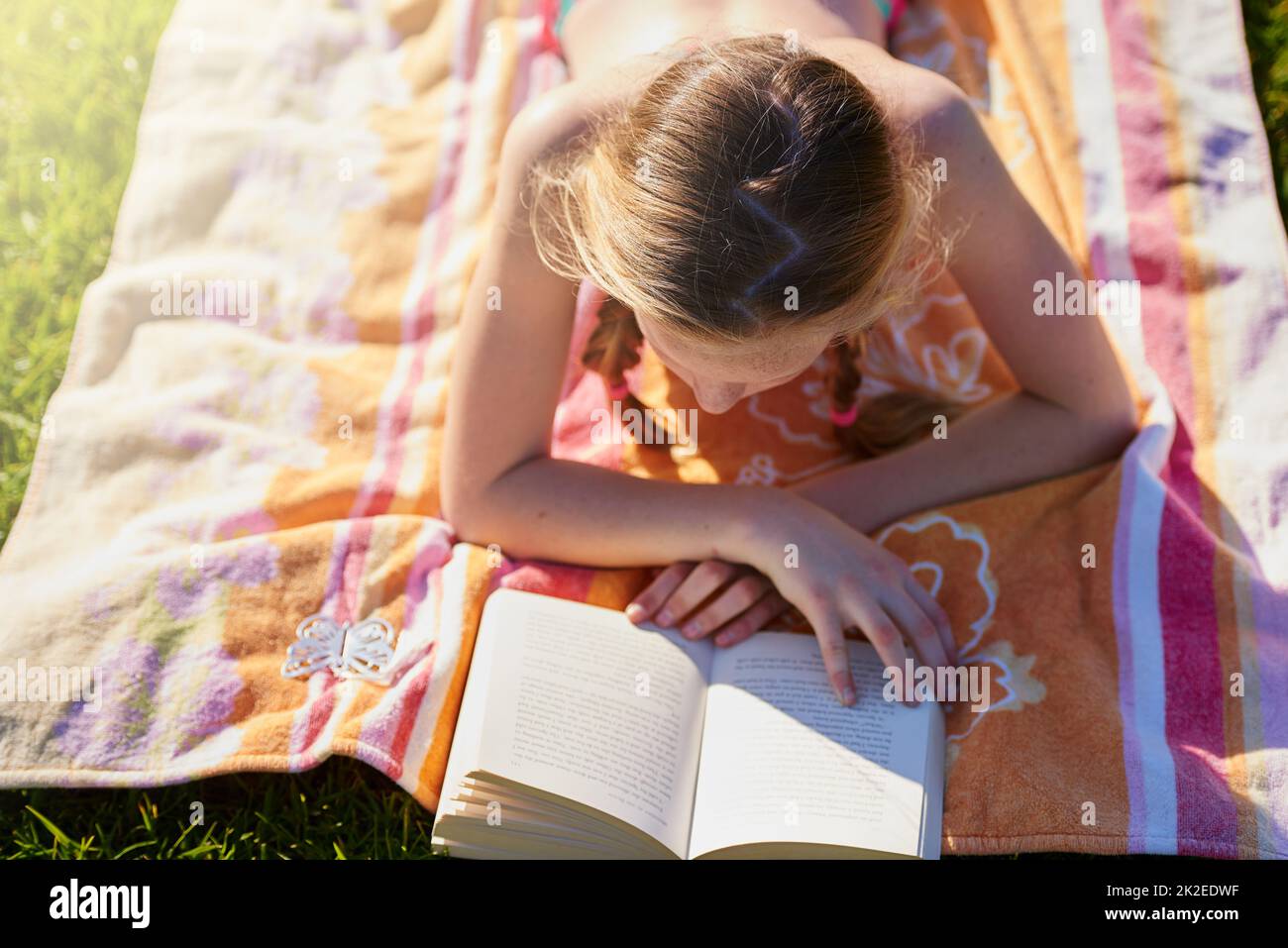 Preteen girl lying on grass hi-res stock photography and images - Alamy