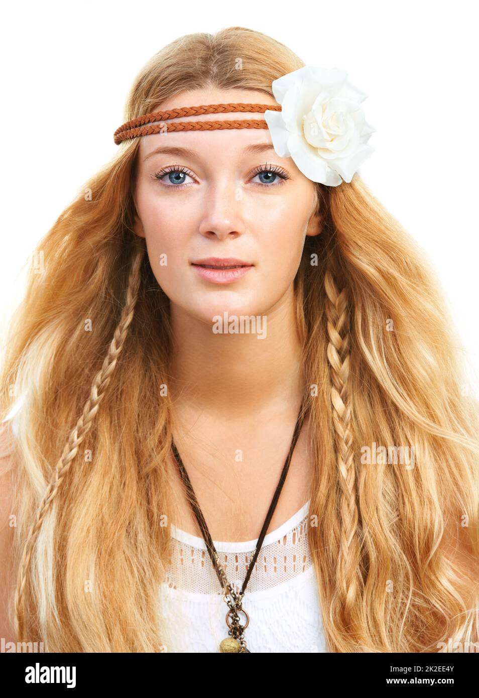Flowers in her hair. Studio shot of an attractive flower child isolated
