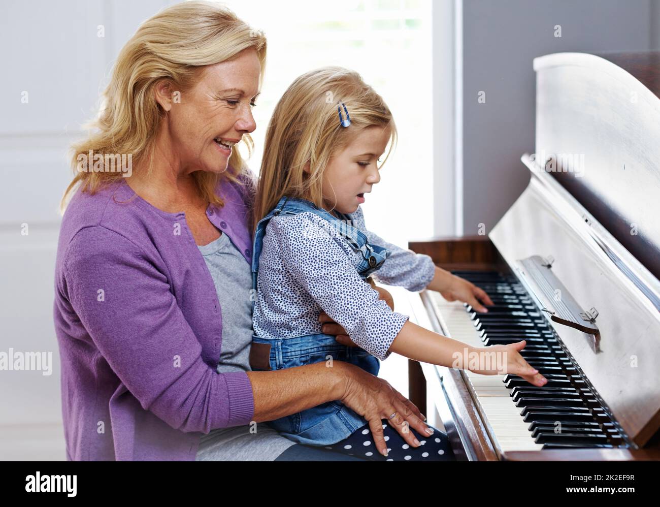 She reminds me of her mother. Cute little girl being taught how to play ...