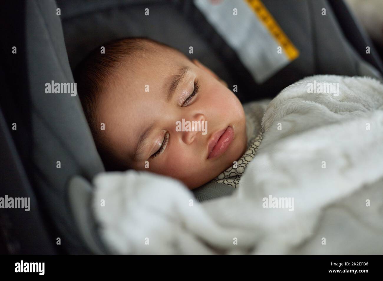 This car trip is going to be a dream. Shot of an adorable baby boy sleeping in a car seat. Stock Photo