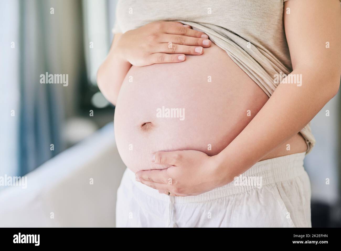 I cant wait to hold you in my arms. Cropped shot of a woman holding her