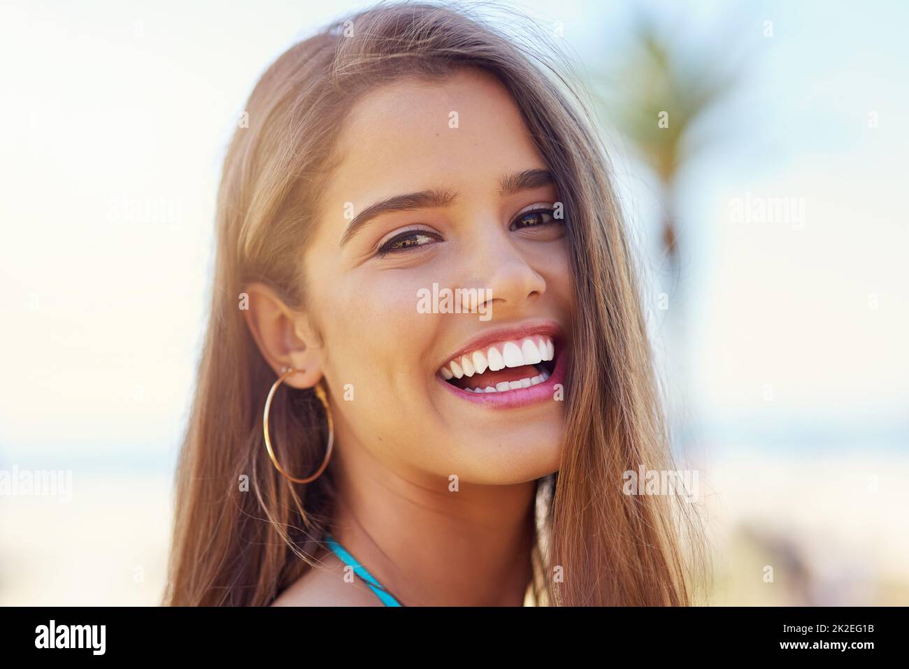 The beach is the only place I need to be. Portrait of an attractive young woman standing outside on a sunny day. Stock Photo