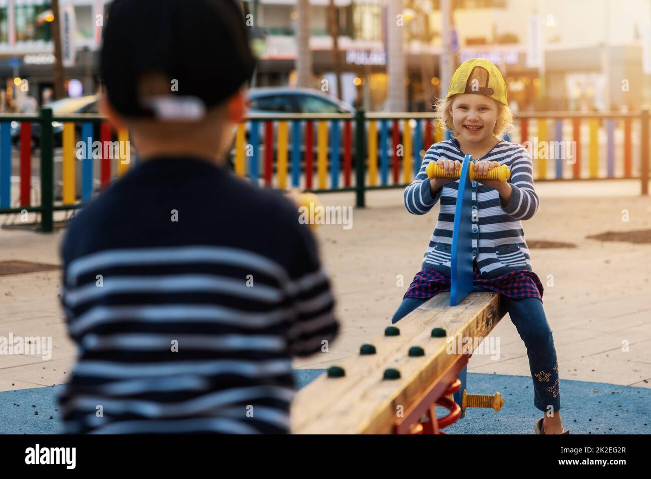 happy children having fun on balance swing at city playground Stock Photo