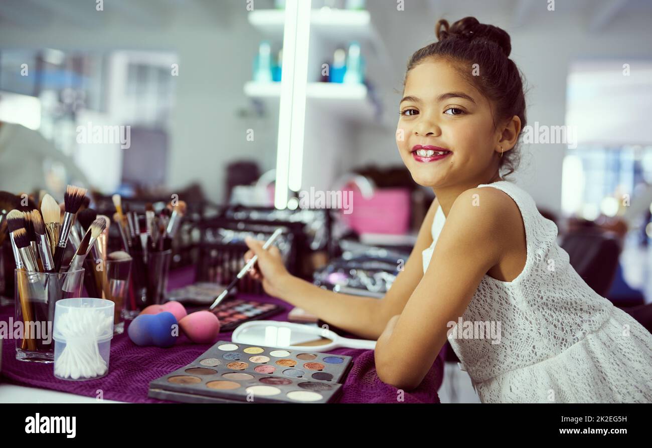 I didnt choose the pageant life, pageant life chose me. Portrait of a cute little girl playing with makeup in a dressing room. Stock Photo