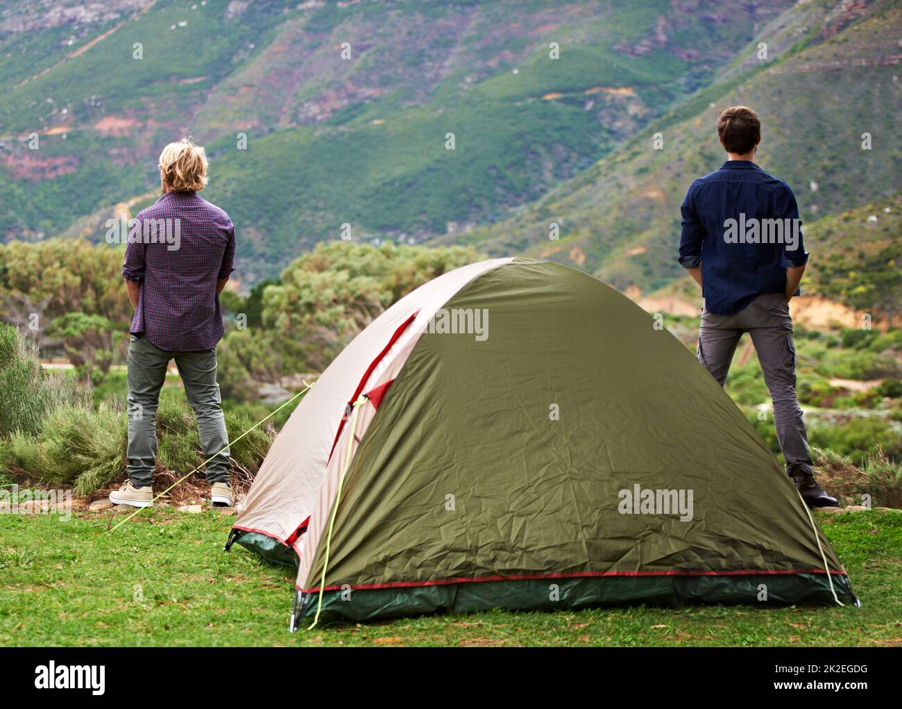 Taking in natures magnificence. Two men relaxing at their campsite. Stock Photo