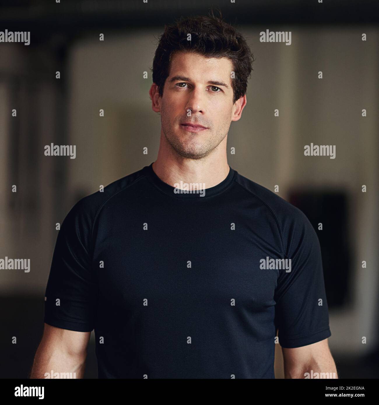 Ready to get ripped. Portrait of a fit man standing in a gym Stock