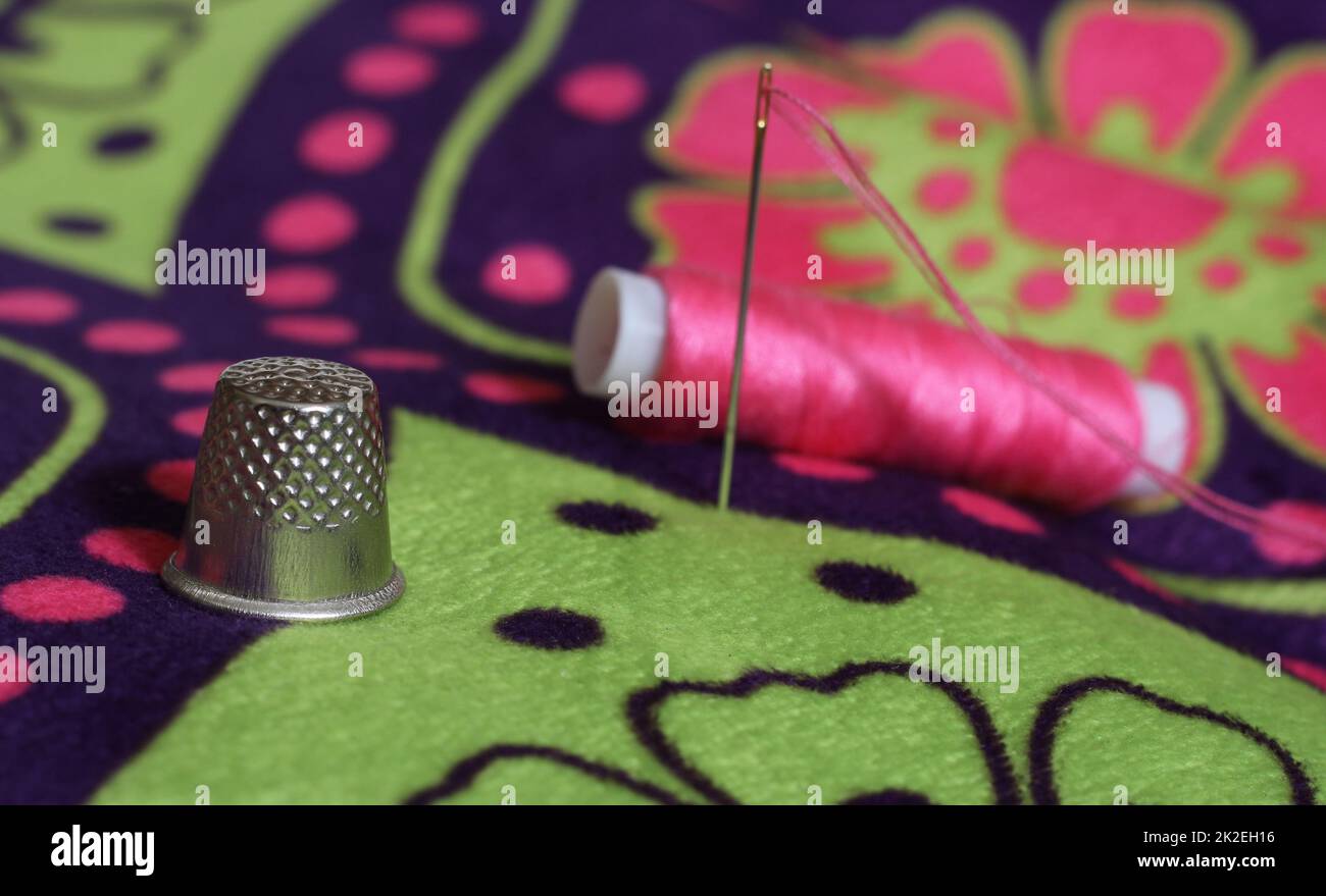 Thimble and Spool of Pink Thread on Vintage Floral Fabric Stock Photo Alamy